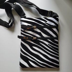 Black and white bag with 3 pockets with straps.